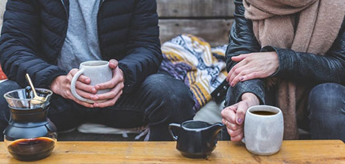 couple drinking coffee outside
