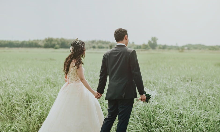 bride and groom on a field