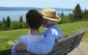 Couple sat on a garden bench in an East facing garden