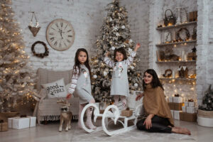 a woman and children celebrating in a Scandi Christmas themed living room