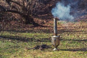 a smoking chiminea by a picnic